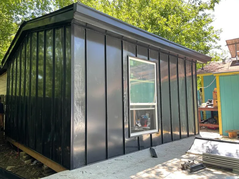 Black standing seam metal wall panels for Roof Inspection in Senatobia