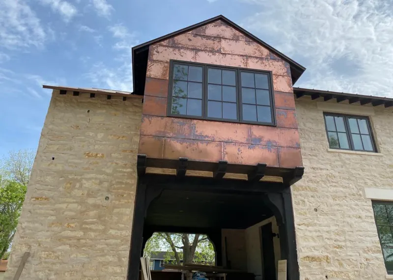 Copper metal panel facade on a stone building for Skylight Installation in Senatobia